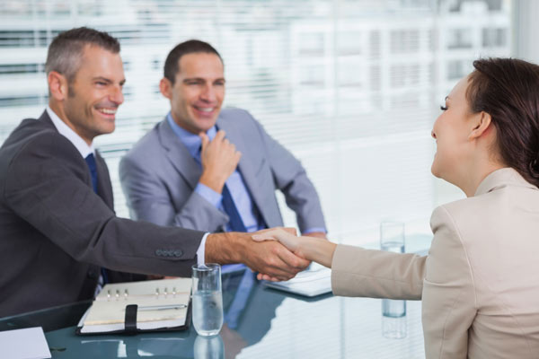 Business workers shaking hands