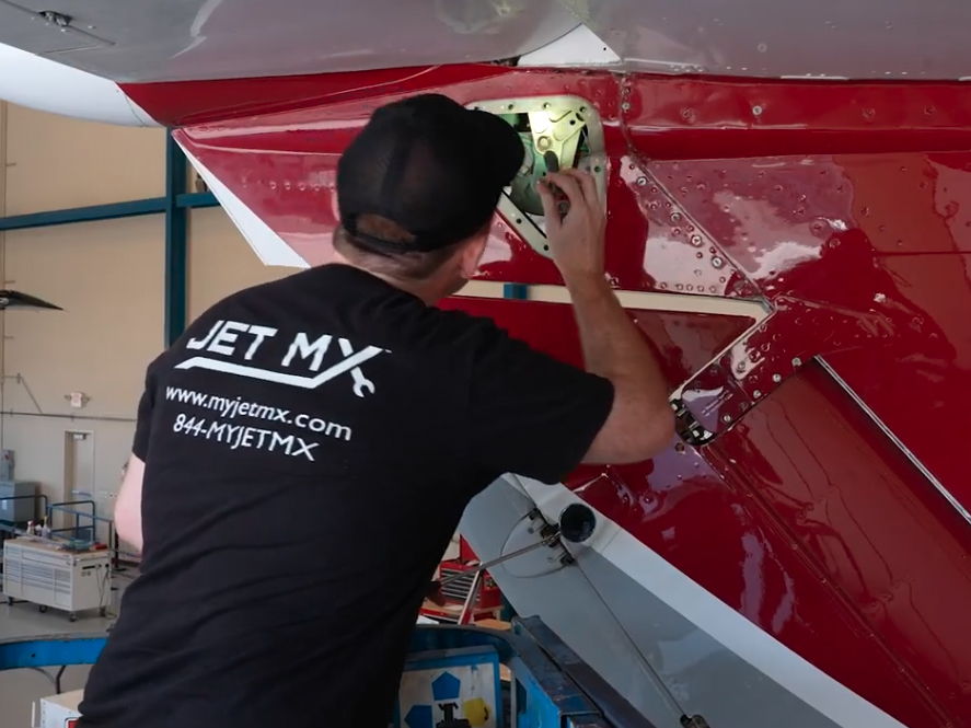 Worker inspecting jet plane
